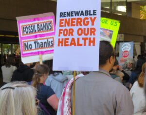 People marching with signs protesting use of fossil fuels Climate strike 2024 