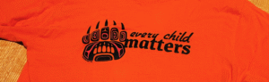 close up image of an orange shirt stating every child matters for Truth and Reconciliation day